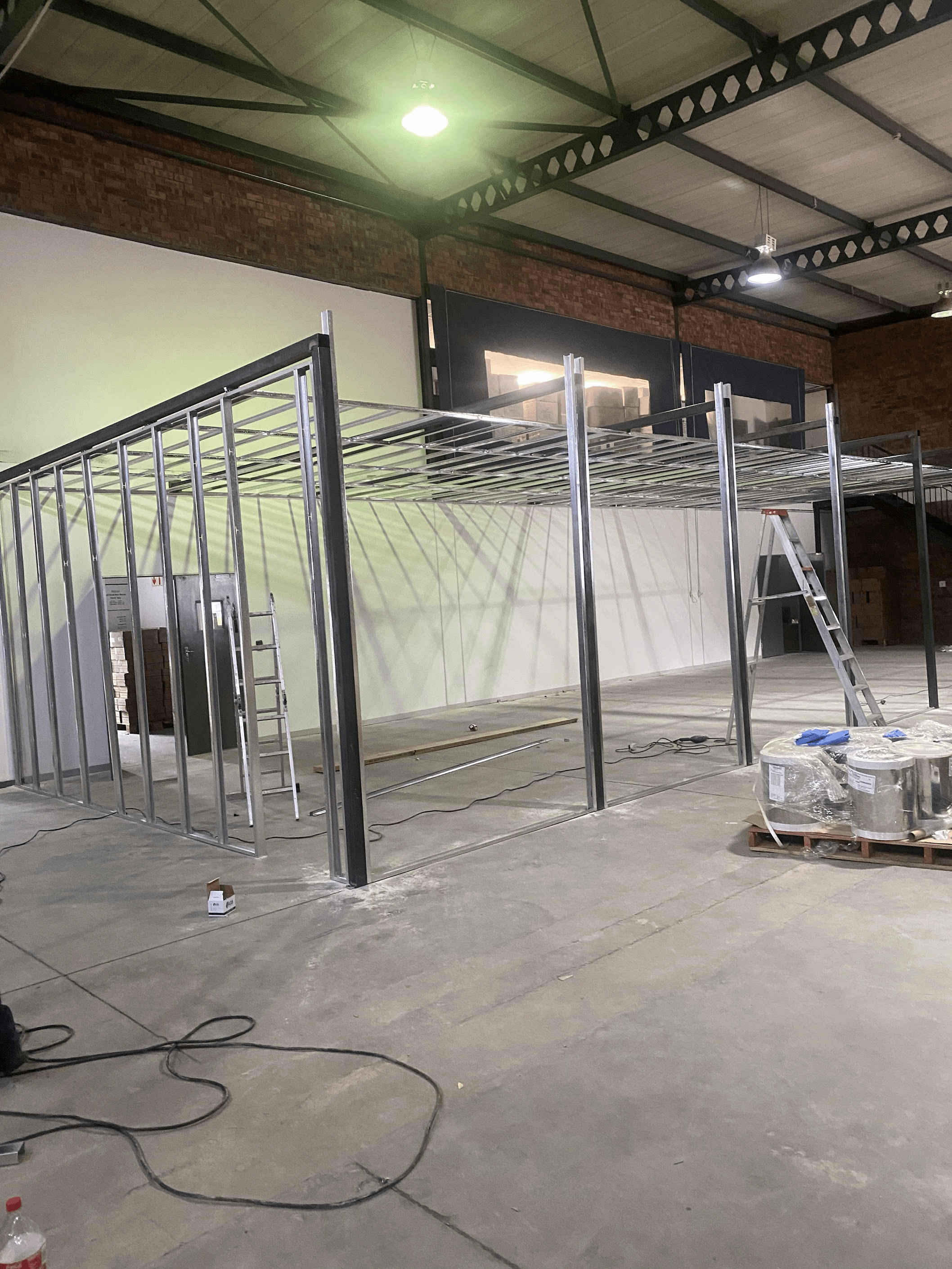 Steel-stud partitioning and ceiling grid installed inside a Johannesburg warehouse