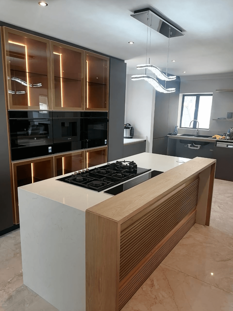 Completed kitchen with custom joinery, stone tops and integrated lighting
